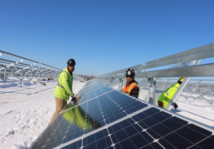 UBC millwrights working on solar panels