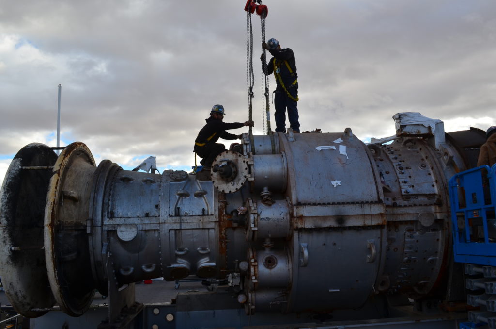 UBC millwrights using pulleys on a turbine