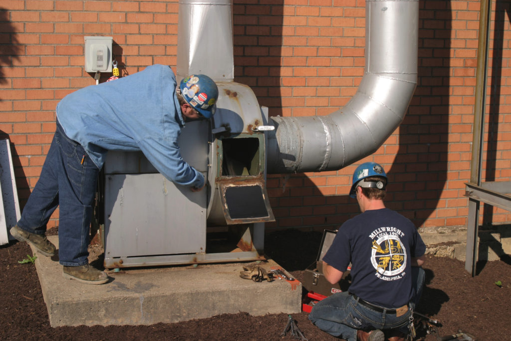 UBC millwrights fixing an industrial blower