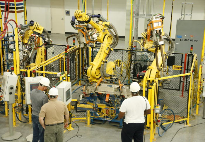 UBC millwrights inspecting industrial robots